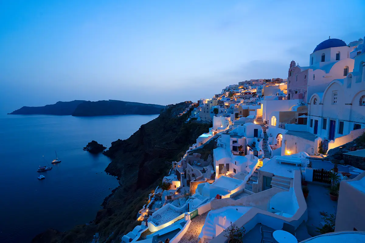 Il tradizionale villaggio greco di Oia a Santorini, con le cupole blu delle chiese e i tetti del paese di notte